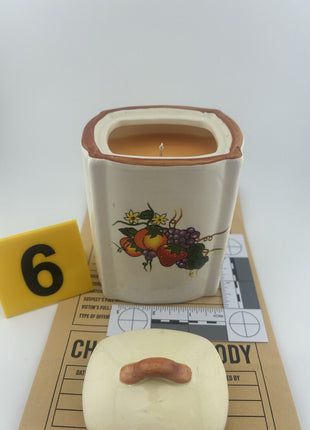 Vandalism Exhibit: Vintage ceramic kitchen canister with fruit motif