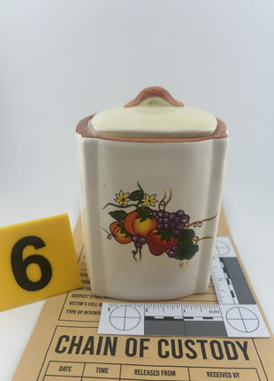 Vandalism Exhibit: Vintage ceramic kitchen canister with fruit motif